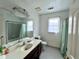 Bathroom featuring a vanity with a large mirror, bathtub, and ample lighting for a functional space at 350 Rams Way, Tucker, GA 30084