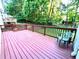 Spacious wooden deck with railing, overlooking lush greenery, perfect for outdoor relaxation at 350 Rams Way, Tucker, GA 30084