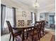 Formal dining room with a wooden table, six chairs, and sheer curtains at 350 Rams Way, Tucker, GA 30084