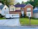 Charming two-story home with brick and siding exterior, attached garage, and well-manicured lawn at 350 Rams Way, Tucker, GA 30084