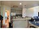 Open kitchen featuring counter seating, stainless steel appliances, and seamless flow to living room at 350 Rams Way, Tucker, GA 30084