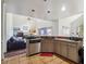 Open-concept kitchen with a breakfast bar overlooking the living room area at 350 Rams Way, Tucker, GA 30084