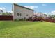Large backyard featuring a lawn, a deck, and a wooden fence. Plenty of room for outdoor activities at 5022 Audubon Pl, Norcross, GA 30093