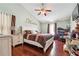 Primary bedroom with vaulted ceilings, ceiling fan, and hardwood floors at 5022 Audubon Pl, Norcross, GA 30093