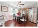 Bright dining area features modern table, stainless steel fridge and elegant china cabinet at 5022 Audubon Pl, Norcross, GA 30093