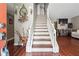 Inviting entryway with hardwood floors, staircase with white railing, and decorative accents at 5022 Audubon Pl, Norcross, GA 30093