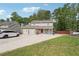 Inviting two-story home boasts stone accents, attached garage, large driveway and solar panels on the roof at 5022 Audubon Pl, Norcross, GA 30093