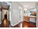 Hallway with beautiful hardwood floors leading to a bathroom and a bedroom at 5022 Audubon Pl, Norcross, GA 30093