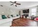 Cozy living room with hardwood floors, plush sofas, and a modern entertainment center at 5022 Audubon Pl, Norcross, GA 30093