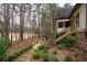 Landscaped backyard features a wooden walkway and golf course view, offering a serene outdoor space at 6213 Arnall Nw Ct, Acworth, GA 30101
