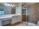 Bathroom featuring a glass-enclosed shower, tile floors, and ample counter space at 6213 Arnall Nw Ct, Acworth, GA 30101