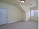 Bright bedroom with neutral walls, carpet, a side window, and a door at 6213 Arnall Nw Ct, Acworth, GA 30101