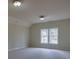 Cozy bedroom featuring neutral walls, carpet, and a large window offering natural light at 6213 Arnall Nw Ct, Acworth, GA 30101