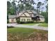 Charming two-story home with a stone and siding exterior, a well-manicured lawn and mature landscaping at 6213 Arnall Nw Ct, Acworth, GA 30101
