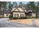 Charming two-story home with a stone and siding exterior, a well-manicured lawn and mature landscaping at 6213 Arnall Nw Ct, Acworth, GA 30101