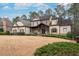 Charming two-story home with a stone and siding exterior, a well-manicured lawn and mature landscaping at 6213 Arnall Nw Ct, Acworth, GA 30101