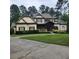 Charming two-story home with a stone and siding exterior, a well-manicured lawn and mature landscaping at 6213 Arnall Nw Ct, Acworth, GA 30101