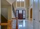 Spacious home foyer featuring tile floors, grand staircase and a beautiful entry door at 6213 Arnall Nw Ct, Acworth, GA 30101