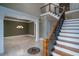Spacious home foyer featuring tile floors, grand staircase, chandelier, and views into the adjacent living spaces at 6213 Arnall Nw Ct, Acworth, GA 30101