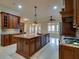 Spacious kitchen boasts a large island, custom cabinets, stainless appliances, and a gas cooktop at 6213 Arnall Nw Ct, Acworth, GA 30101