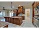 Elegant kitchen featuring custom wood cabinetry, granite countertops, and a large center island with sink at 6213 Arnall Nw Ct, Acworth, GA 30101
