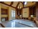 Grand living room with beamed ceilings, custom built-ins, and large windows offering abundant natural light at 6213 Arnall Nw Ct, Acworth, GA 30101