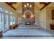 Open living space featuring a grand stone fireplace, high ceilings, and floor-to-ceiling windows for abundant natural light at 6213 Arnall Nw Ct, Acworth, GA 30101