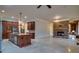 Living room open to kitchen with stone fireplace, kitchen island with seating, and a view into another living space at 6213 Arnall Nw Ct, Acworth, GA 30101