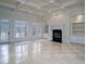 Bright, expansive living room with coffered ceilings, fireplace, built-in shelves, and access to the outdoor space at 6213 Arnall Nw Ct, Acworth, GA 30101