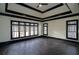 Large living room featuring hardwood floors, trey ceilings, recessed lighting, and large windows at 6213 Arnall Nw Ct, Acworth, GA 30101