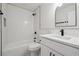 Modern bathroom with white subway tile, black accents, and a bathtub-shower combo at 3343 Mooring Dr, Powder Springs, GA 30127