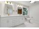 Updated bathroom featuring double vanity, modern fixtures, and a window for natural light at 3343 Mooring Dr, Powder Springs, GA 30127