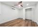Bright bedroom featuring hardwood floors, a ceiling fan, split unit, and a closet at 3343 Mooring Dr, Powder Springs, GA 30127