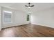 This bedroom includes wood-look flooring, a ceiling fan, and multiple windows for natural light at 3343 Mooring Dr, Powder Springs, GA 30127