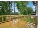 Wooden deck with lush green views, surrounded by trees and a wooden fence at 3343 Mooring Dr, Powder Springs, GA 30127