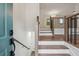 Inviting entryway showcasing hardwood steps, a staircase with metal accents, and views into the living spaces at 3343 Mooring Dr, Powder Springs, GA 30127
