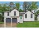 Charming home featuring a two-car garage, a beautifully manicured lawn, and a stylishly designed entrance at 3343 Mooring Dr, Powder Springs, GA 30127