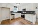 Bright kitchen equipped with stainless steel appliances, stylish backsplash, and white cabinets at 3343 Mooring Dr, Powder Springs, GA 30127