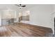 Spacious living room featuring hardwood floors, a fireplace, and an open design leading to other living spaces at 3343 Mooring Dr, Powder Springs, GA 30127