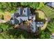 Aerial view of an estate home featuring manicured grounds, a private courtyard, and a stunning dark roof at 3863 Streamside Se Dr, Marietta, GA 30067