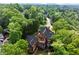 Breathtaking aerial view showcases this beautiful home nestled among the surrounding mature tree canopy at 3863 Streamside Se Dr, Marietta, GA 30067