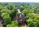Stunning aerial view of a secluded home surrounded by dense trees and lush landscaping at 3863 Streamside Se Dr, Marietta, GA 30067