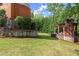 Secluded backyard featuring a lush lawn and outdoor fireplace with a pergola for entertaining at 3863 Streamside Se Dr, Marietta, GA 30067