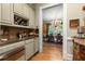 Elegant bar area featuring a wine rack and marble countertops, leading into dining room at 3863 Streamside Se Dr, Marietta, GA 30067