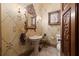 Powder room with pedestal sink, decorative walls, and elegant lighting at 3863 Streamside Se Dr, Marietta, GA 30067