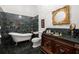 Bathroom featuring marble floors and walls, a clawfoot tub, and a decorative vanity at 3863 Streamside Se Dr, Marietta, GA 30067