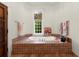 A full tub with a picture window, and decorative towels and gold fixtures at 3863 Streamside Se Dr, Marietta, GA 30067