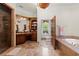 Bathroom with a large soaking tub, walk-in shower, marble floors and rich wood cabinetry at 3863 Streamside Se Dr, Marietta, GA 30067