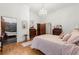 Light-filled bedroom featuring a 4 poster bed, ornate chandelier, and an ensuite bath with a clawfoot tub at 3863 Streamside Se Dr, Marietta, GA 30067