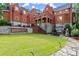 Stunning exterior view of a large home with brick facade, stone accents, and a well-maintained lawn at 3863 Streamside Se Dr, Marietta, GA 30067